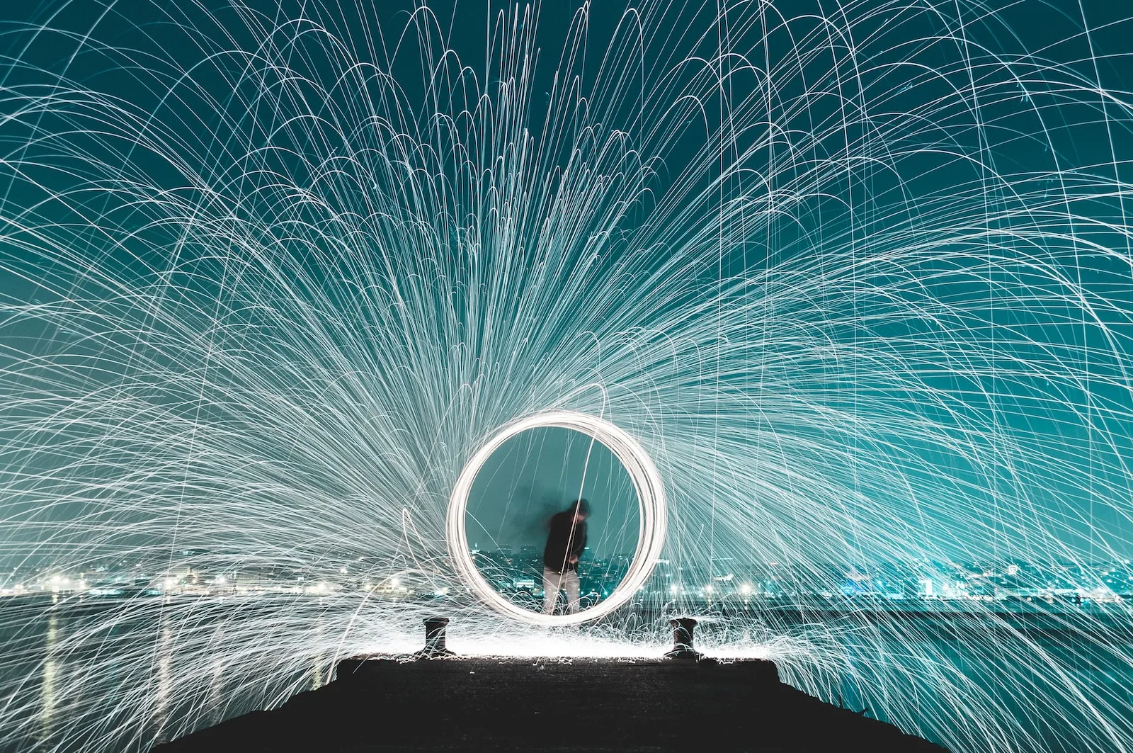 man standing on dock steel wool photography